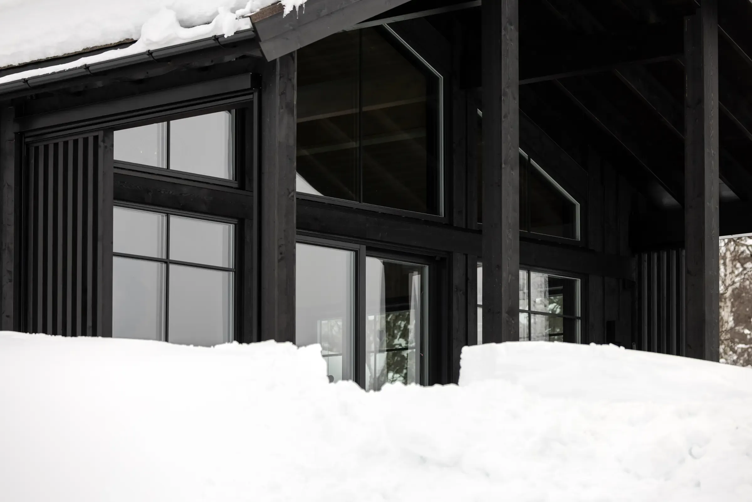 The glass facade of the extension in the snow