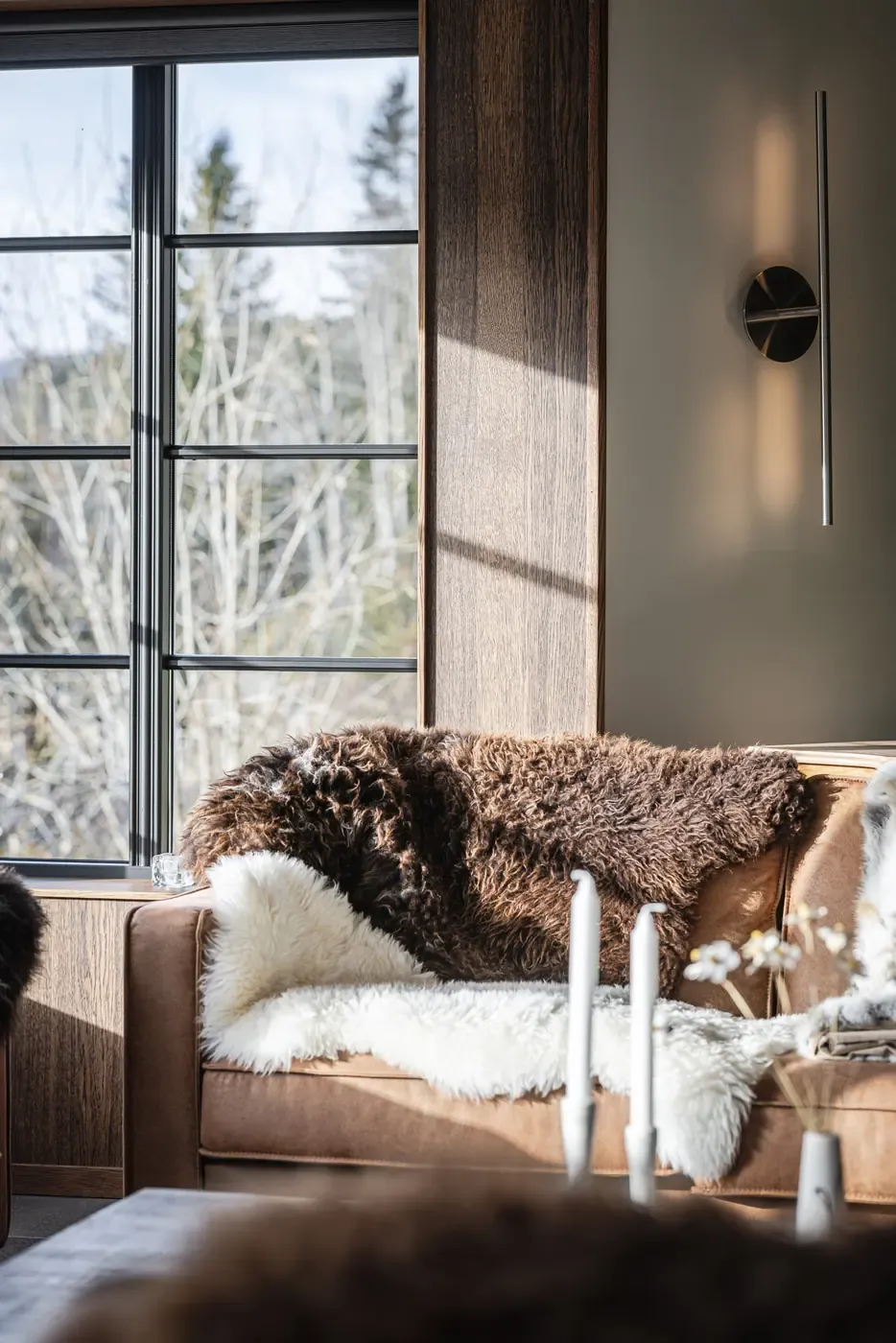 Sofa corner by the window with sheepskin