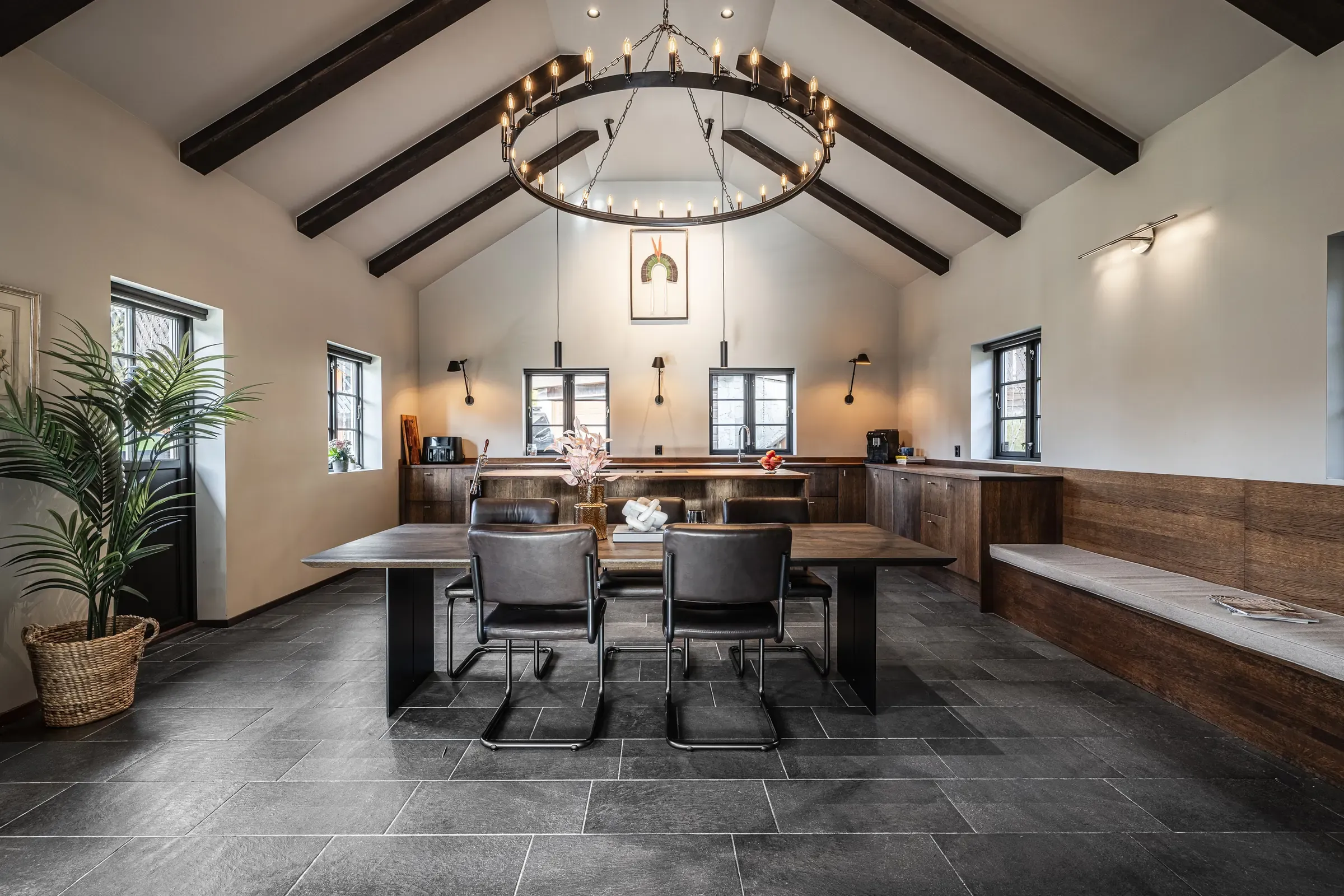 Living and dining room with exposed ceiling beams and slate floor